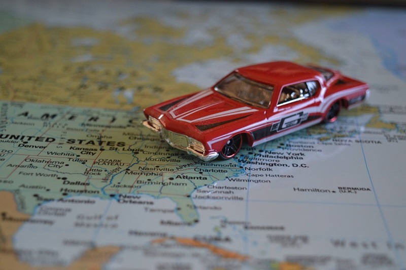 Safe Road Trip a Red Toy Car on a Map of the United States