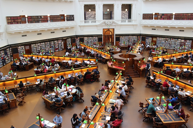 Driving School For Orange County Colleges Overhead View of a College Library Filled with Students