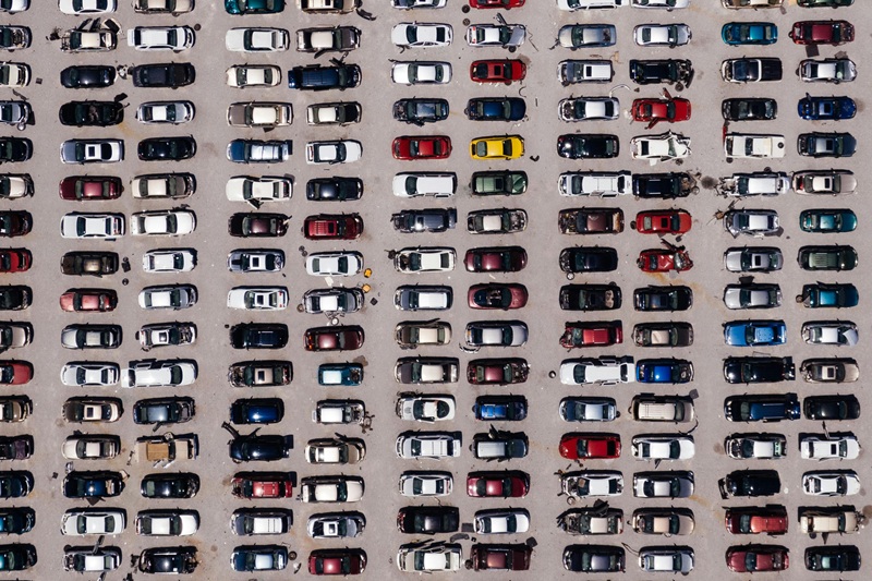 Tips For Parking Between Two Cars in a Parking Lot View From the Sky of a Full Parking Lot