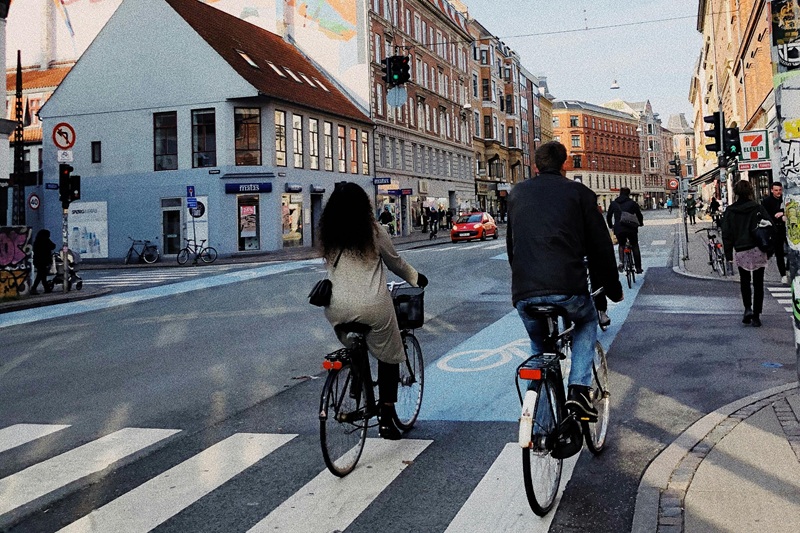 Sharing the Road with Bikers Two People Riding Bicycles in a Bike Lane on a Street