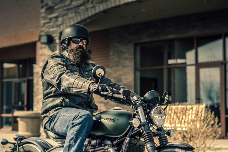 Sharing the Road with Bikers a Man on a Motorcycle Outside a Building