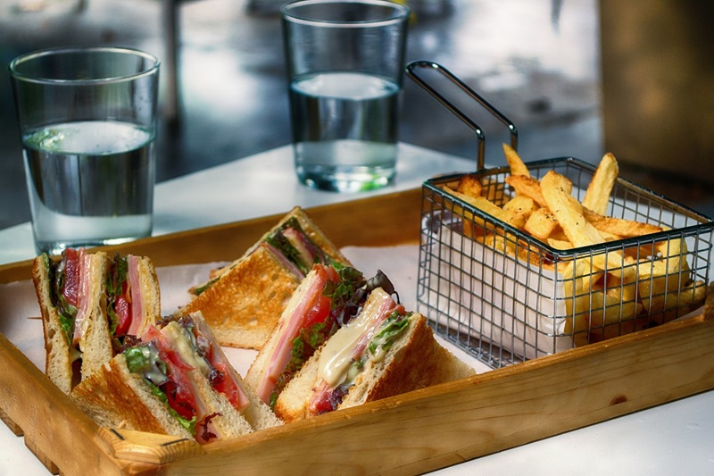 7 Awesome Sandwich Shops in Irvine A Serving Platter with Sandwich Triangles and a Small Fry Basket Filled with French Fries