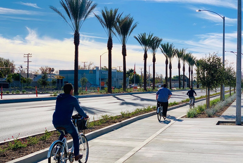 Santa Ana Driving School People Riding Bikes Along Street