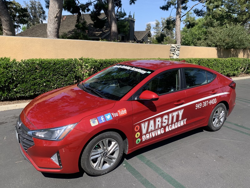 Where to Take Driving Lessons in Tustin and Tustin Ranch Training Vehicle in a Parking Lot