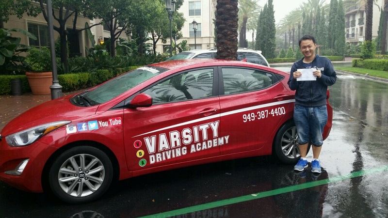 Driving Lessons in San Juan Capistrano Student Standing Next to Training Vehicle