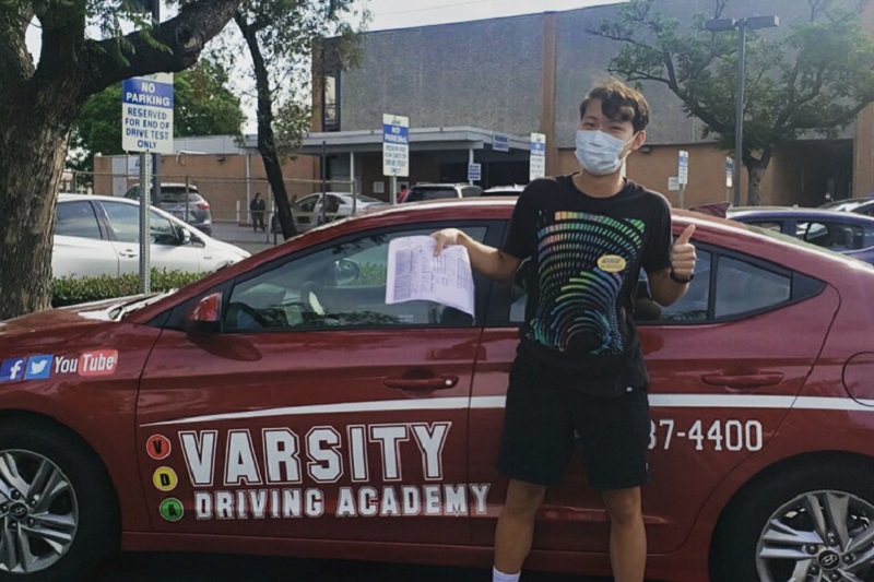 Garden Grove High School Driving School Student Standing Next to a Training Vehicle