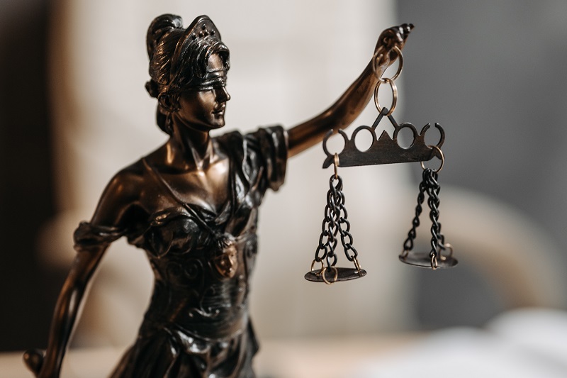 New 2023 Driving Laws Close Up of a Statue of the Lady of Justice Holding Up a Scale While Blindfolded