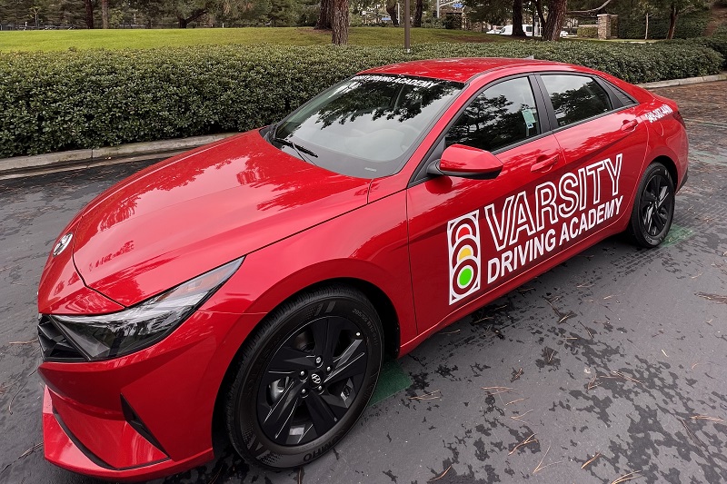 Early College High School Driver's Ed Close Up of a Training Vehicle Parked in a Parking Lot