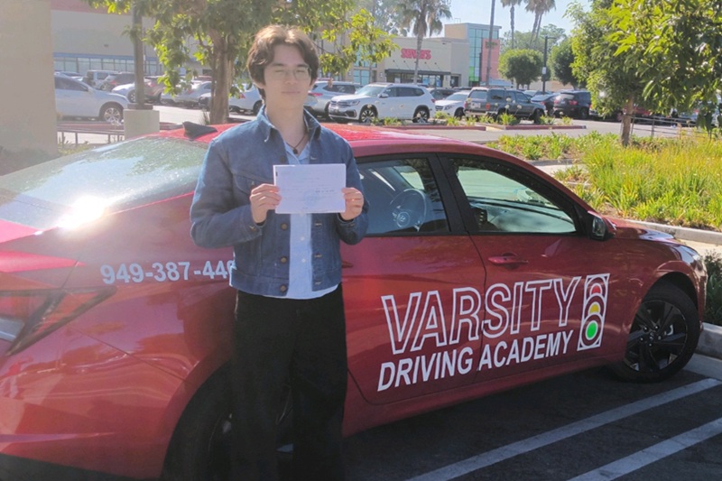 Best Taylion High Desert Academy Behind the Wheel Training Student Standing Next to a Training Vehicle