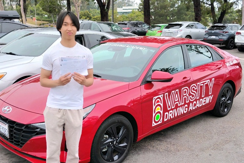 Best Driving School Near Me Irvine Student Standing Next to a Training Vehicle