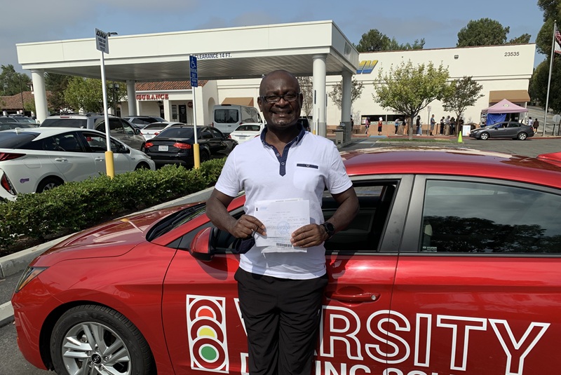 Best Adult Driving School in Tustin Adult Student Standing Next to a Training Vehicle in Parking Lot