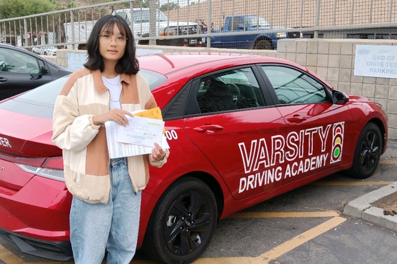 Best Behind the Wheel Training Near Me Tustin Student Standing Next to a Training Vehicle in a Parking Lot