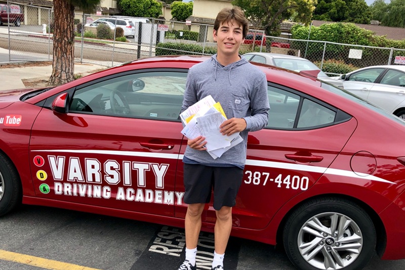 Best Driving School Near Me Tustin California Student Standing Next to a Training Vehicle